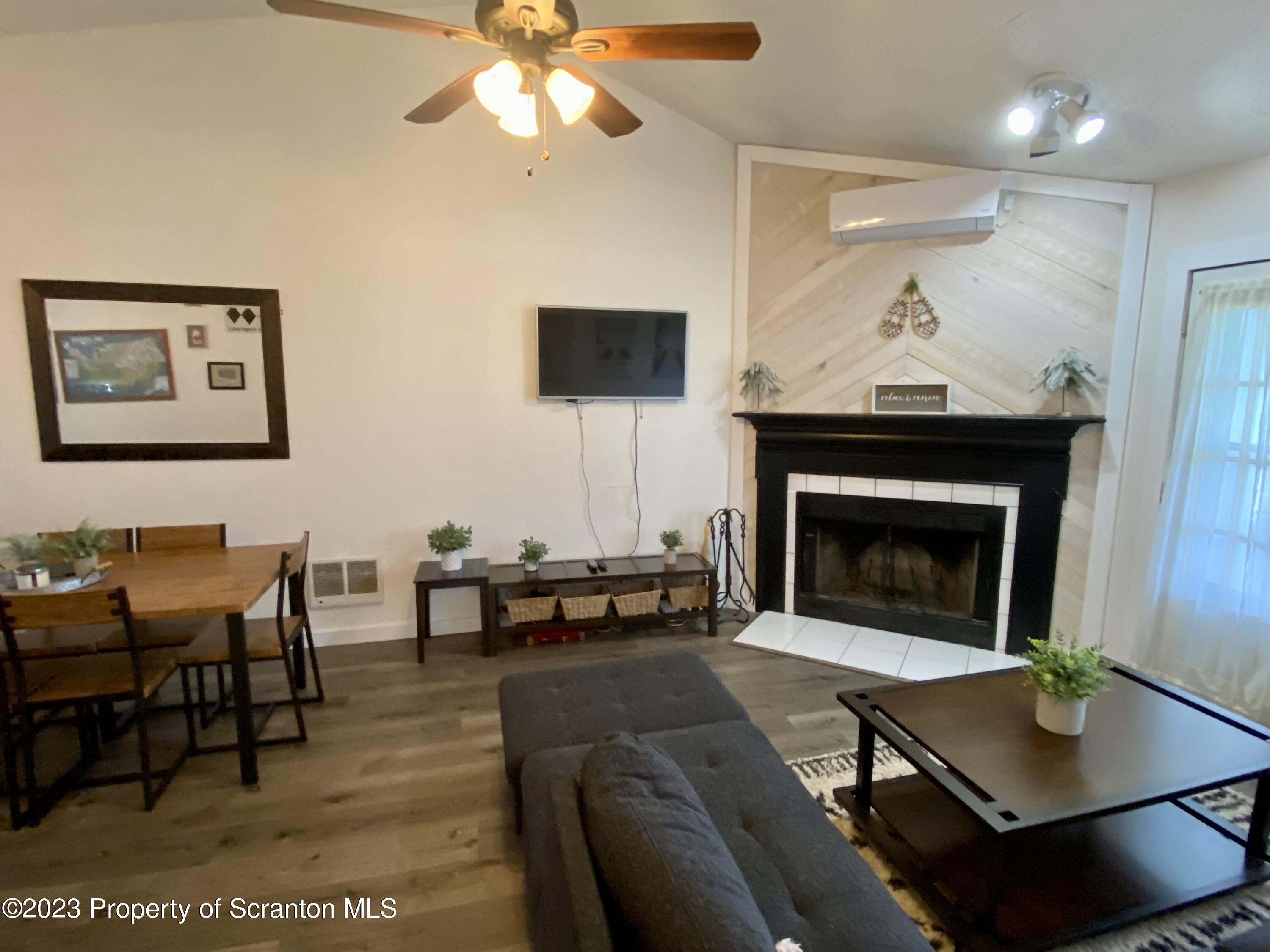 80 Garden Circle, Unit 20 Union Dale, PA 18470 - Photo 12 of 27 a living room with furniture a table and a fireplace