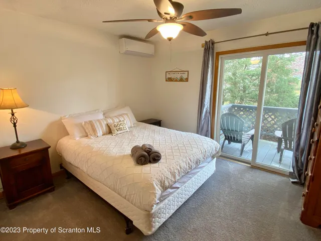 a bedroom with a bed and a large window