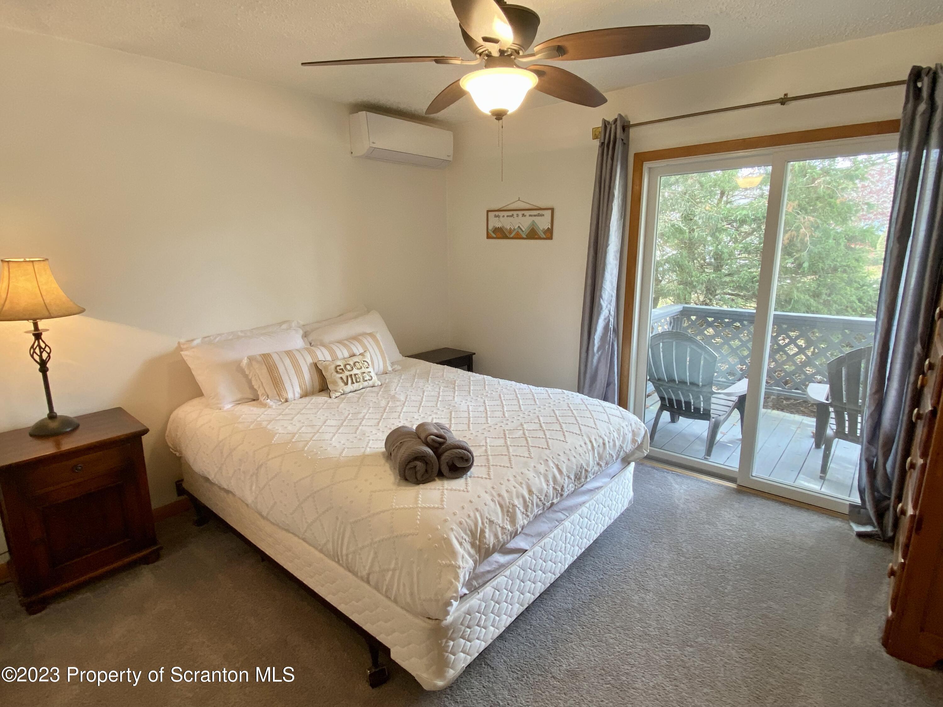 80 Garden Circle, Unit 20 Union Dale, PA 18470 - Photo 16 of 27 a bedroom with a bed and a large window