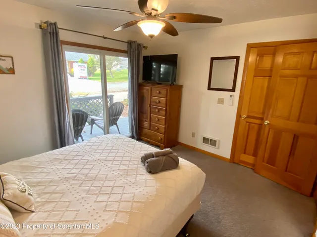 a bedroom with a bed and a mirror