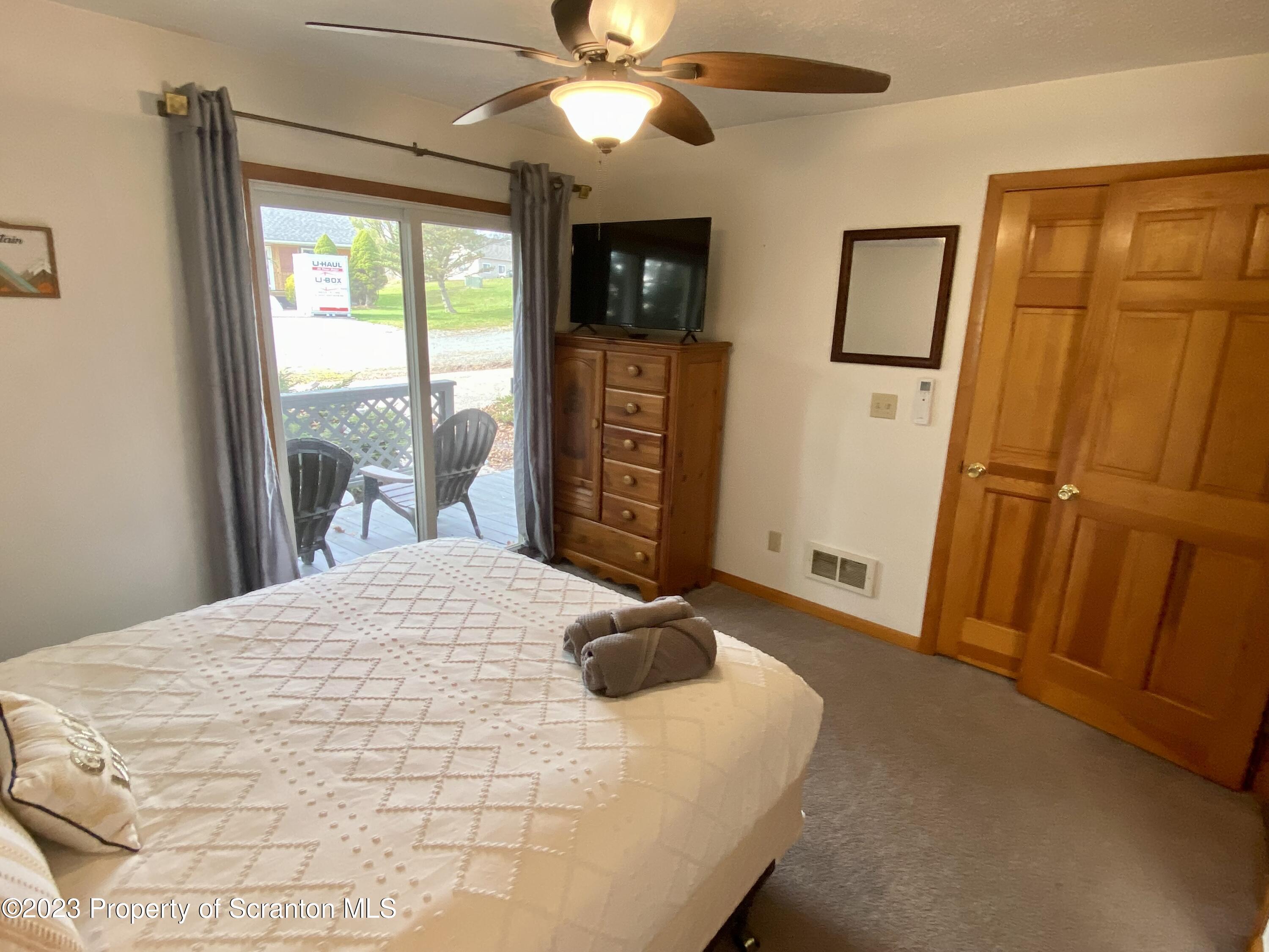 80 Garden Circle, Unit 20 Union Dale, PA 18470 - Photo 17 of 27 a bedroom with a bed and a mirror