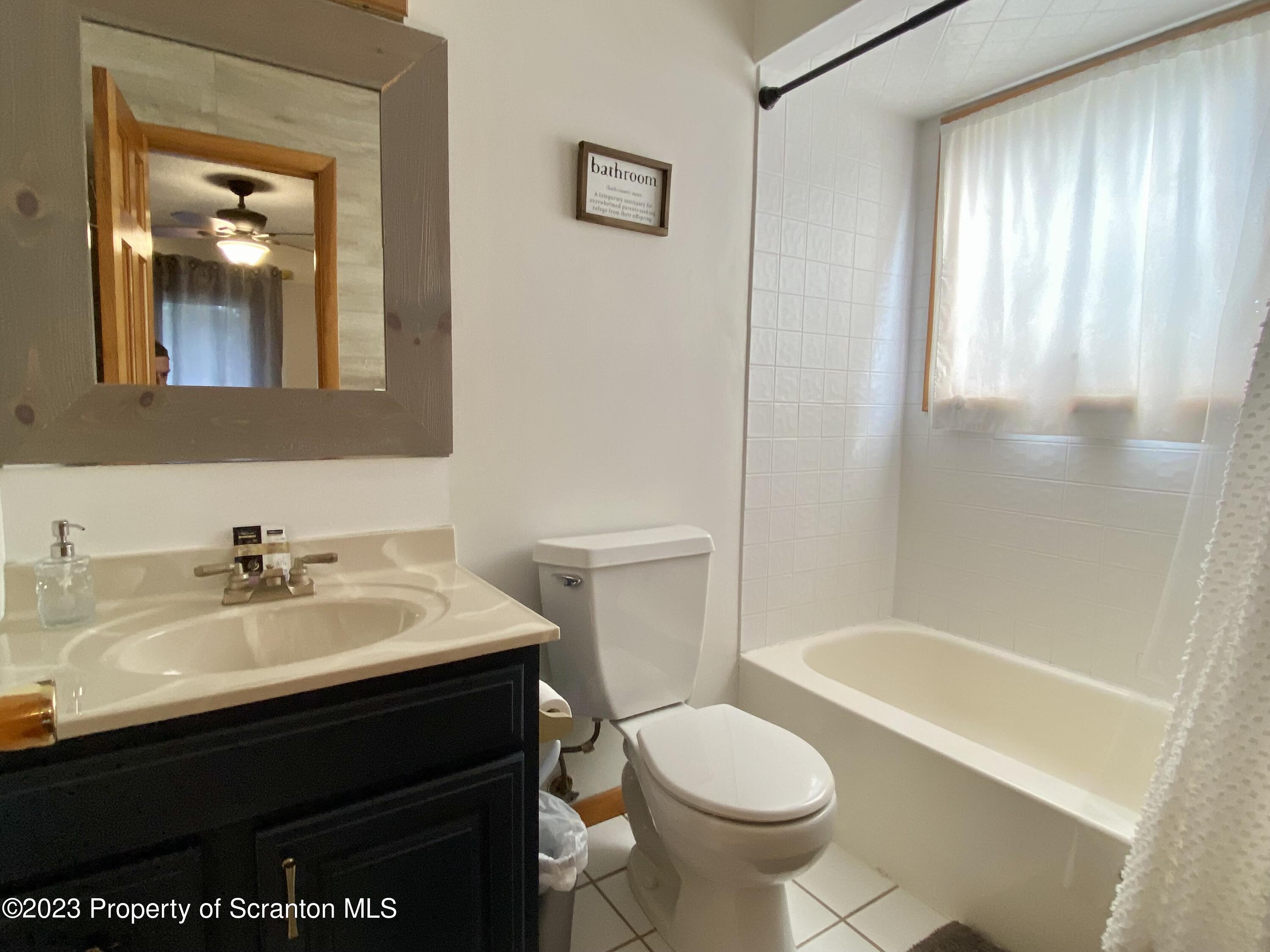 80 Garden Circle, Unit 20 Union Dale, PA 18470 - Photo 18 of 27 a bathroom with a sink a toilet and shower