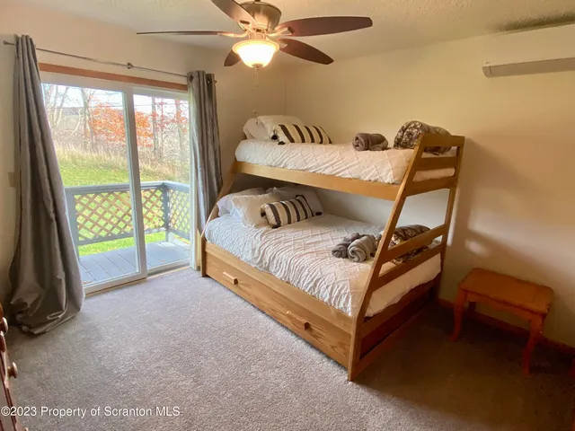 a bed sitting in a bedroom next to a window