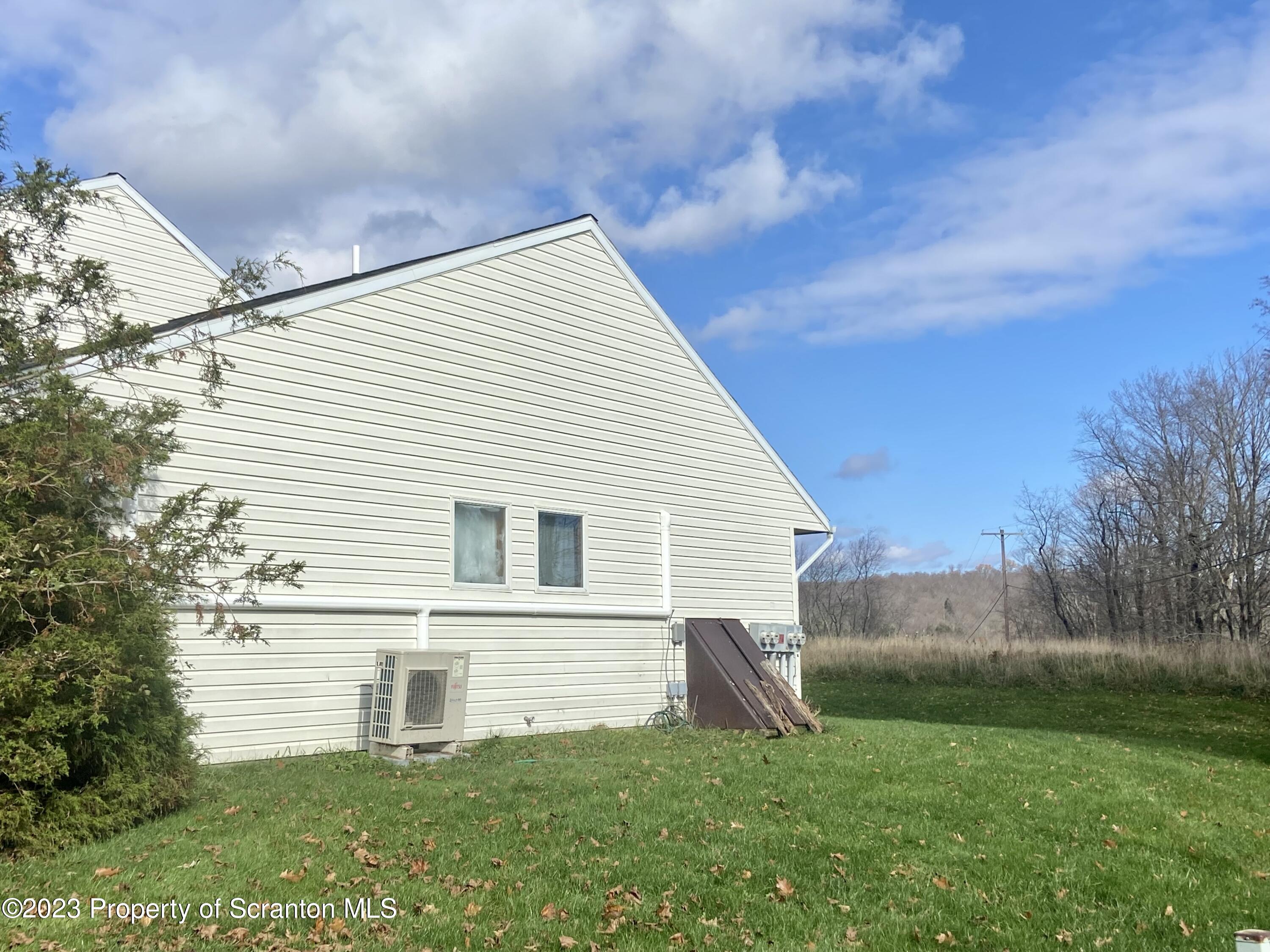 80 Garden Circle, Unit 20 Union Dale, PA 18470 - Photo 2 of 27 a view of backyard with seating area and trees