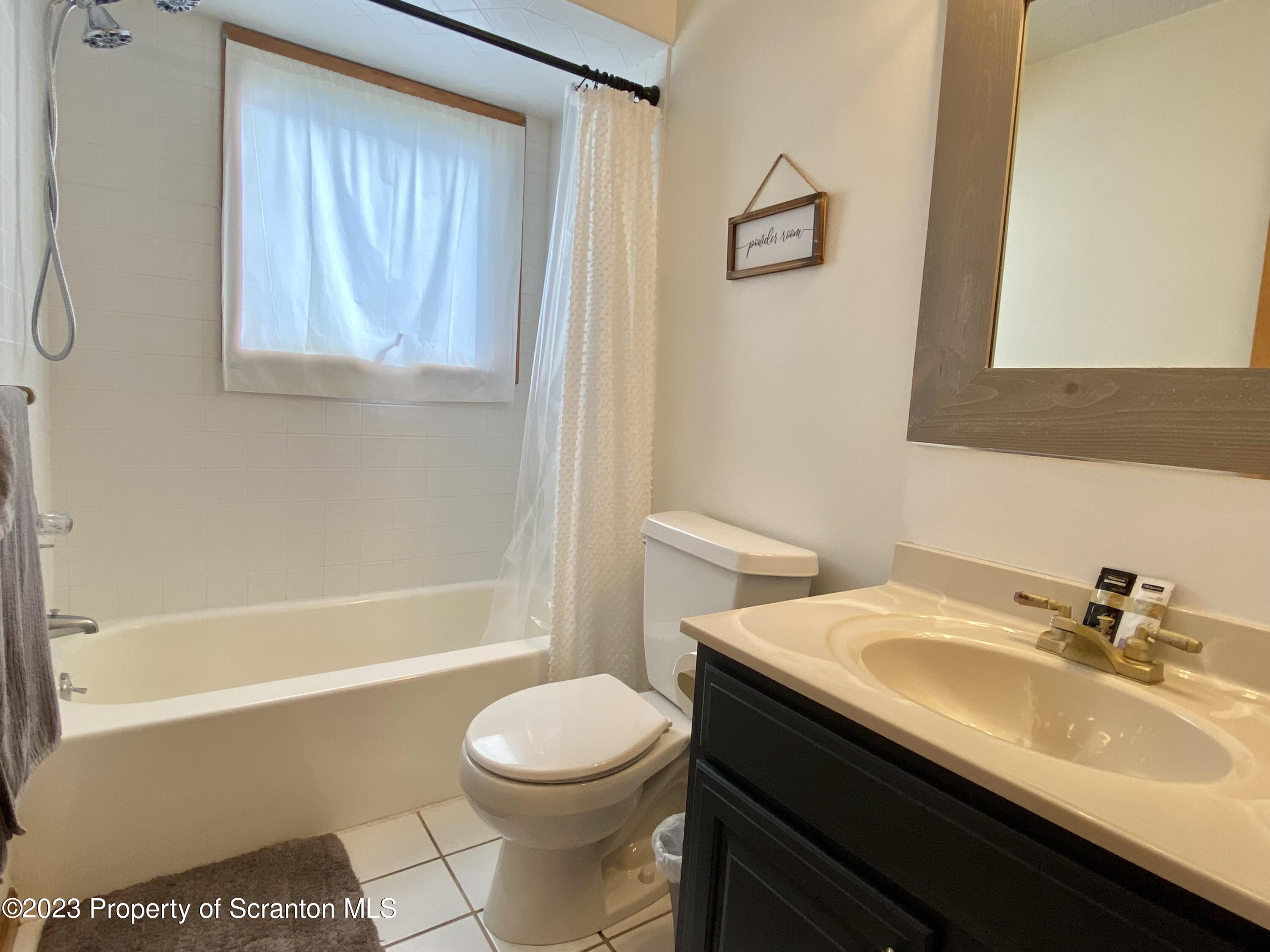 80 Garden Circle, Unit 20 Union Dale, PA 18470 - Photo 21 of 27 a bathroom with a sink a toilet and shower