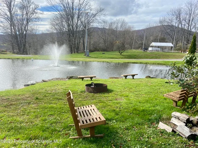 a view of a lake with a yard and a fountain
