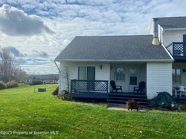 a front view of a house with garden and outdoor seating