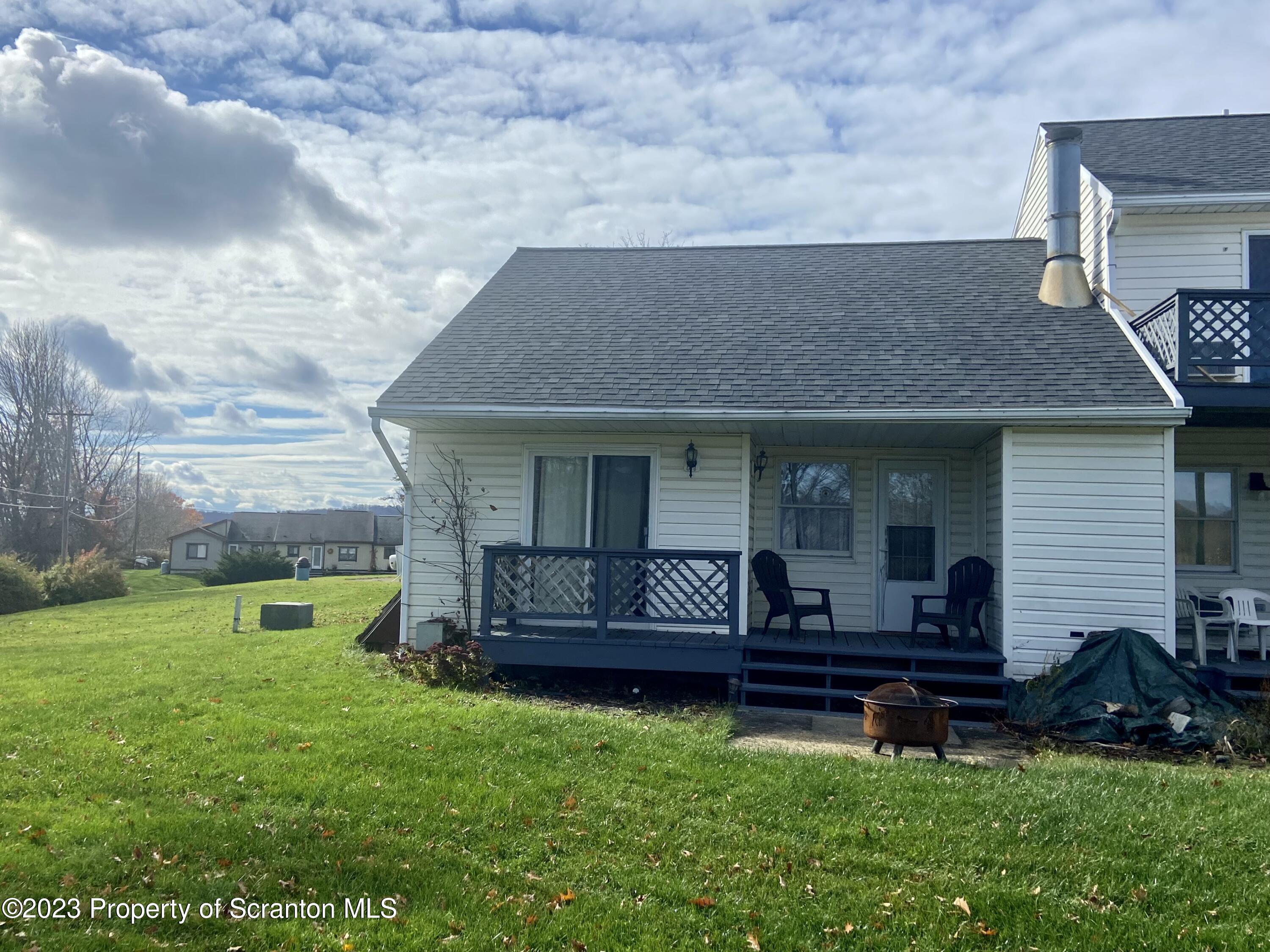 80 Garden Circle, Unit 20 Union Dale, PA 18470 - Photo 3 of 27 a front view of a house with garden and outdoor seating