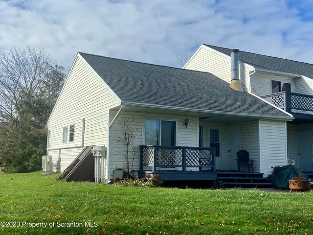 a front view of a house with a garden and plants