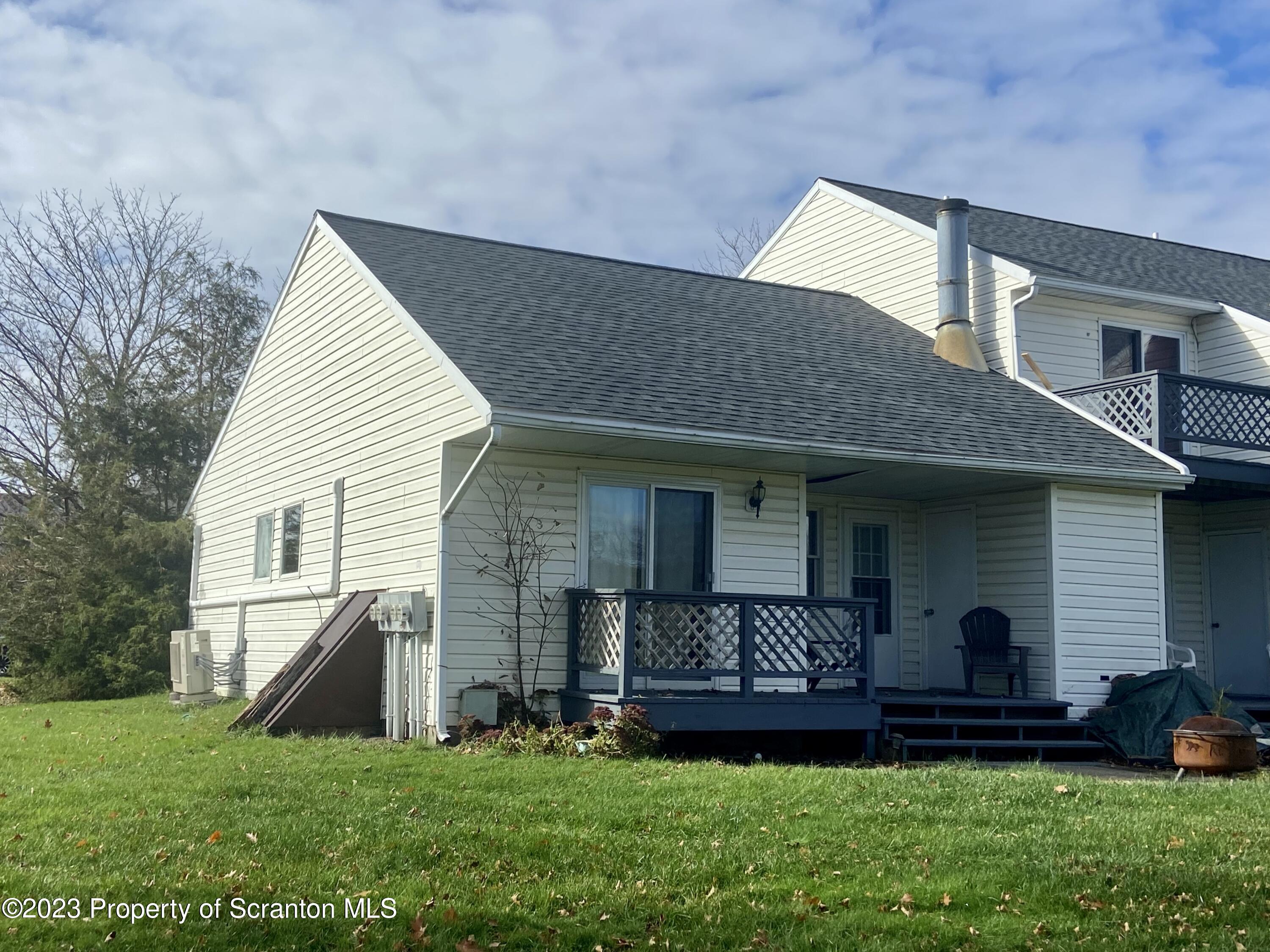 80 Garden Circle, Unit 20 Union Dale, PA 18470 - Photo 4 of 27 a front view of a house with a garden and plants