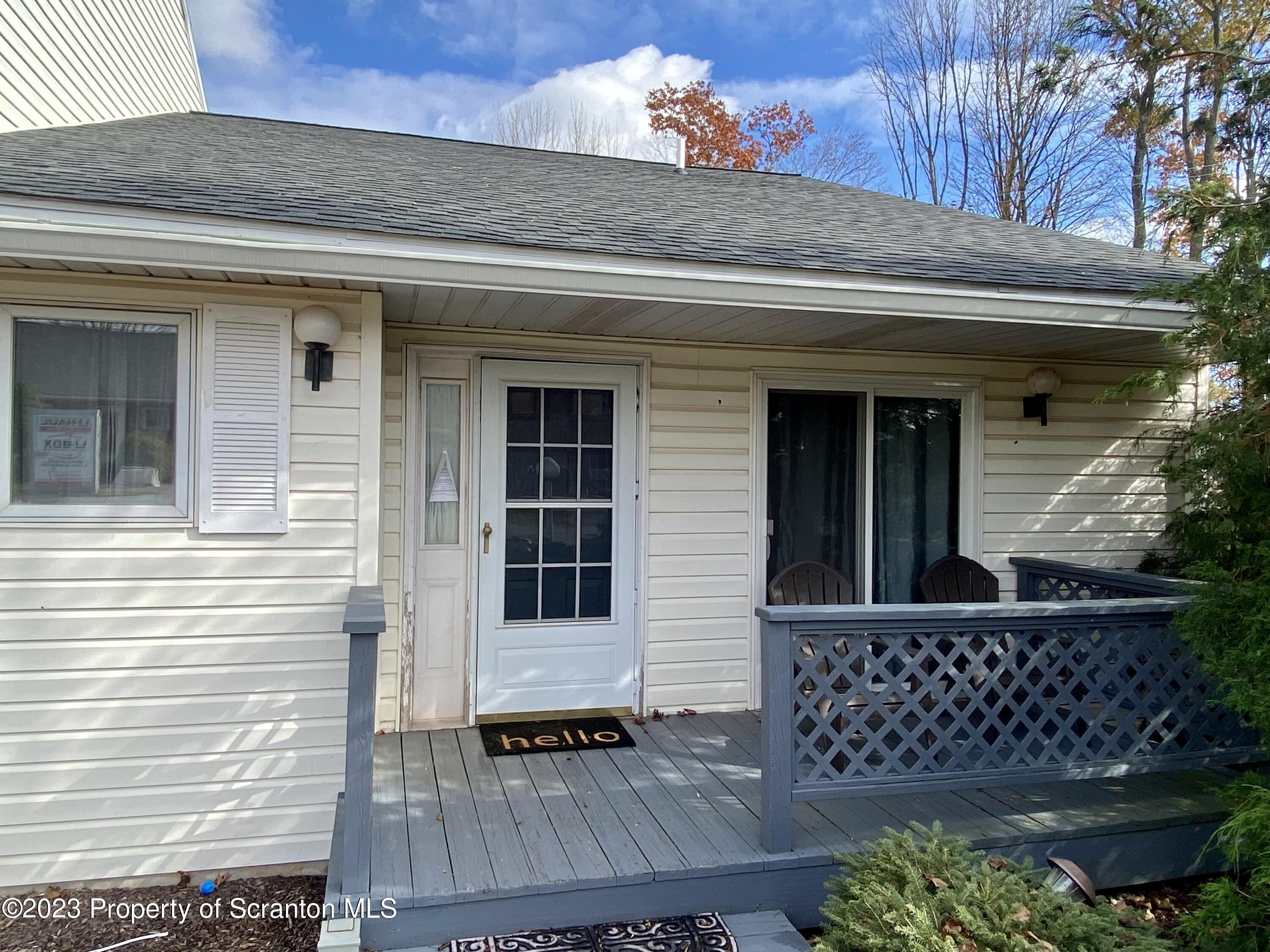 80 Garden Circle, Unit 20 Union Dale, PA 18470 - Photo 6 of 27 a view of house with wooden door and outdoor seating