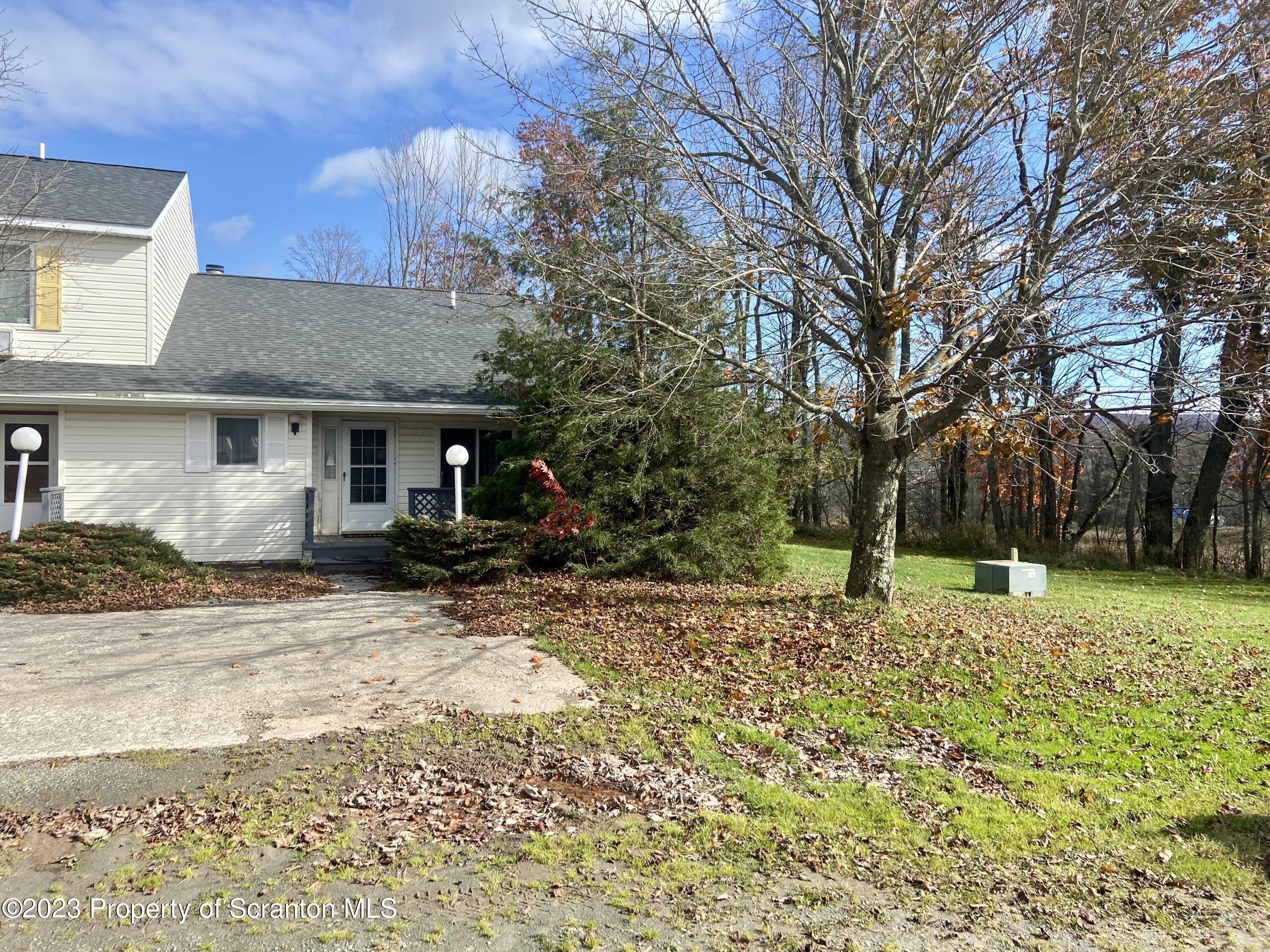 80 Garden Circle, Unit 20 Union Dale, PA 18470 - Photo 7 of 27 a view of a house with a yard covered in snow