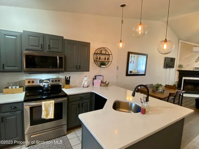 a kitchen with a sink a stove and cabinets