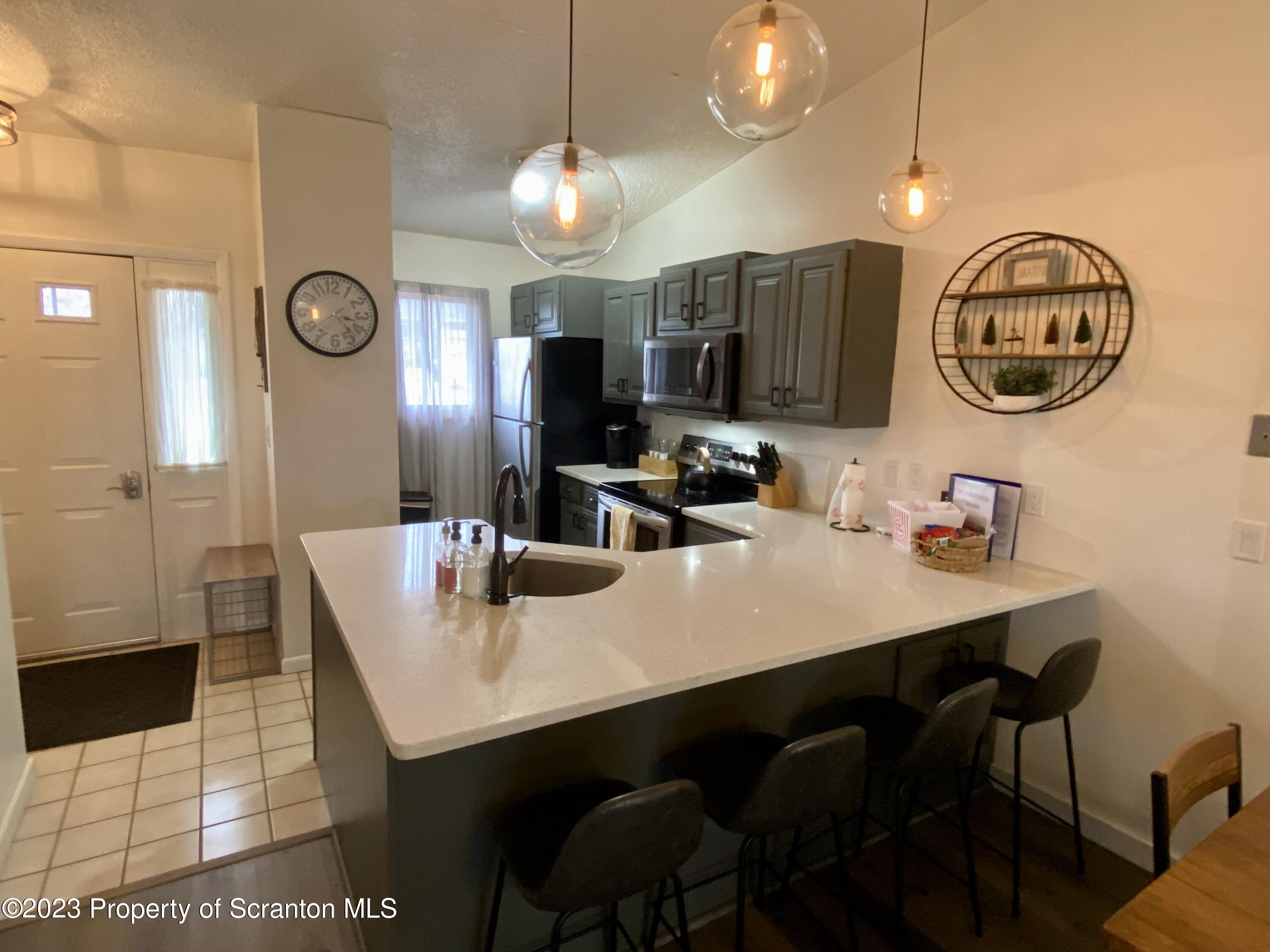 80 Garden Circle, Unit 20 Union Dale, PA 18470 - Photo 10 of 27 a kitchen with a table and chairs in it