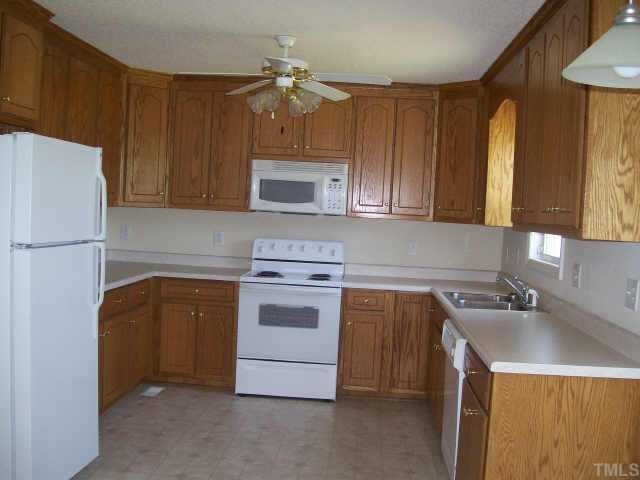 1530 Cleveland Road Smithfield, NC 27577 - Photo 3 of 10 This kitchen has BEAUTIFUL oak finish cabinet and loads of them!!! All appliances convey! FORMICA countertops and a ceiling fan top this room off!