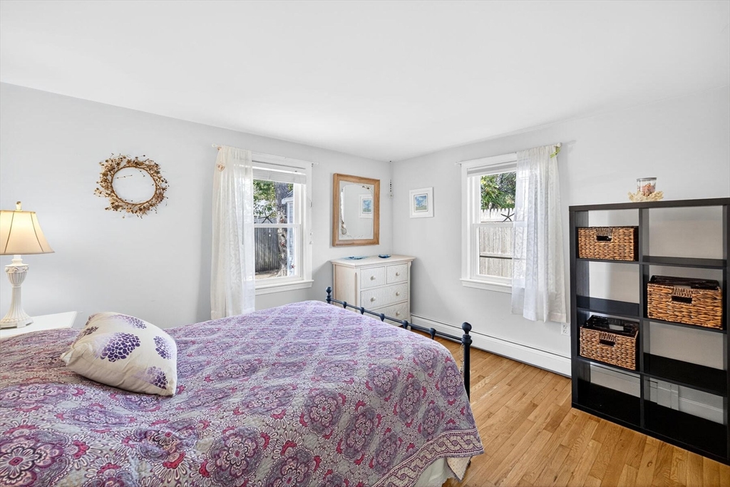 31 Easy Street Dennis, MA 02639 - Photo 17 of 41 a bedroom with a bed and wooden floor