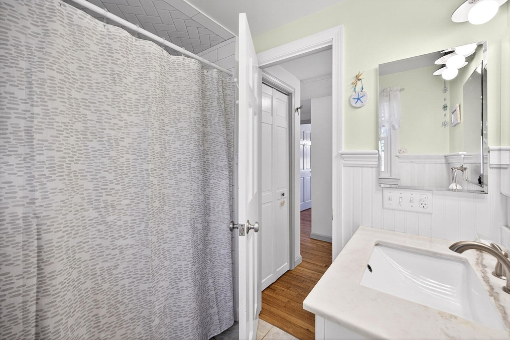 31 Easy Street Dennis, MA 02639 - Photo 20 of 41 a bathroom with a sink a mirror and shower