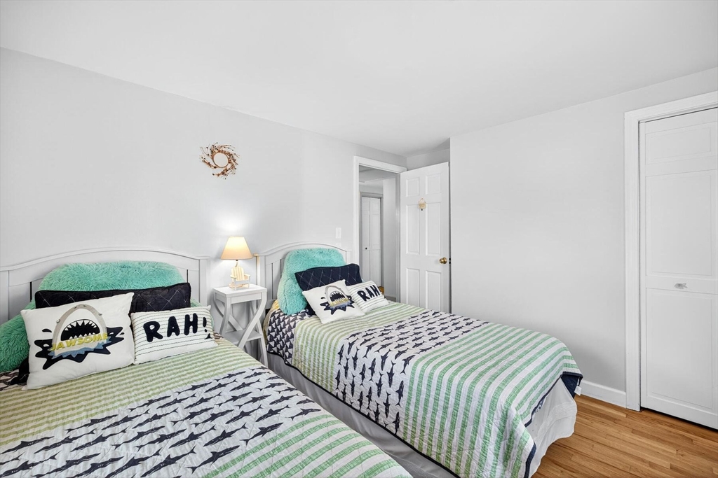 31 Easy Street Dennis, MA 02639 - Photo 23 of 41 a bedroom with a bed and wooden floor