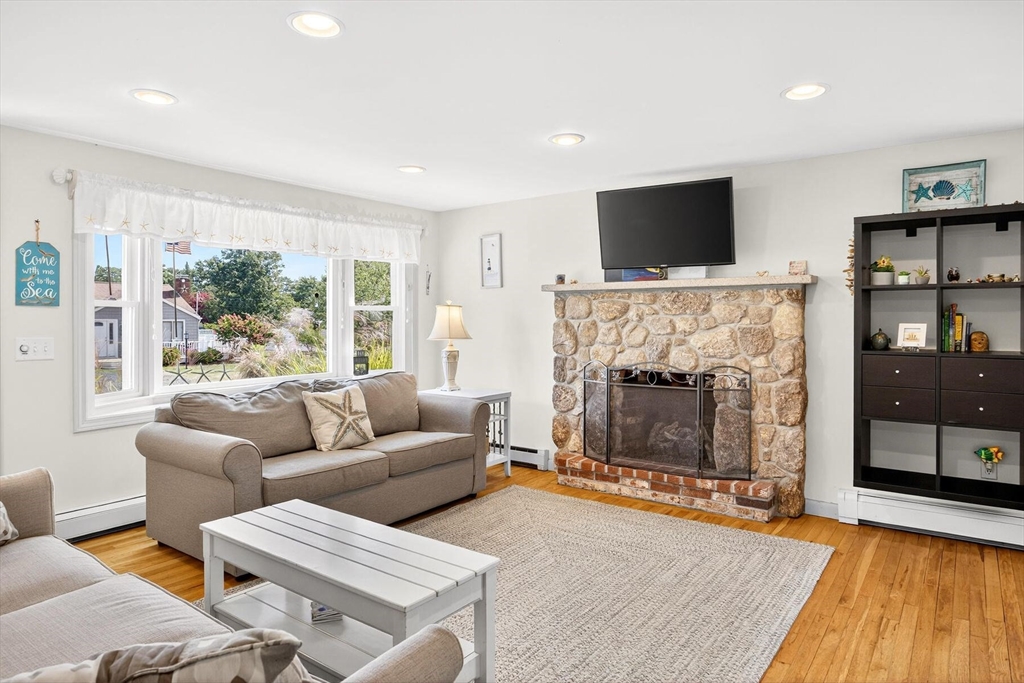 31 Easy Street Dennis, MA 02639 - Photo 3 of 41 a living room with furniture a flat screen tv and a fireplace