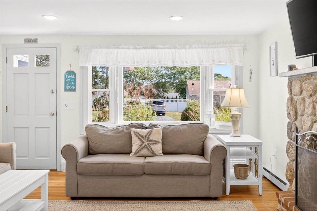 31 Easy Street Dennis, MA 02639 - Photo 6 of 41 a living room with furniture a flat screen tv and a large window