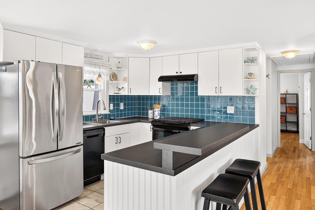 31 Easy Street Dennis, MA 02639 - Photo 8 of 41 a kitchen with stainless steel appliances granite countertop a refrigerator sink and stove