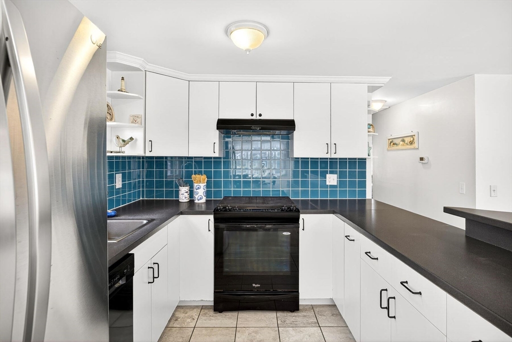 31 Easy Street Dennis, MA 02639 - Photo 9 of 41 a kitchen with granite countertop white cabinets and stainless steel appliances