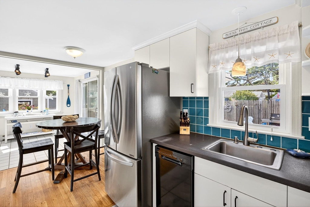 31 Easy Street Dennis, MA 02639 - Photo 10 of 41 a kitchen with stainless steel appliances granite countertop a refrigerator a sink a stove and island