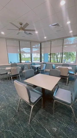 a view of a livingroom with furniture and a bookshelf