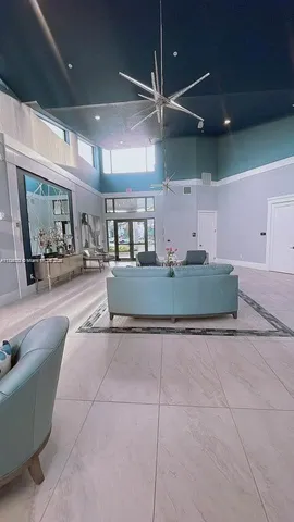 a living room with furniture and a ceiling fan