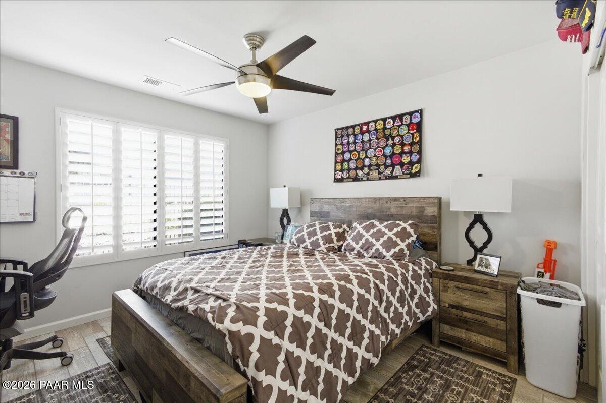 2180 Resort Way South, Unit A7 Prescott, AZ 86301 - Photo 11 of 27 a bedroom with a bed and a chandelier