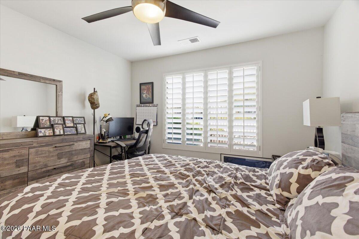2180 Resort Way South, Unit A7 Prescott, AZ 86301 - Photo 12 of 27 a bedroom with a bed and a chandelier