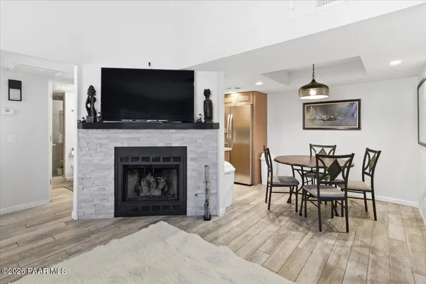 a living room with furniture a flat screen tv and a fireplace