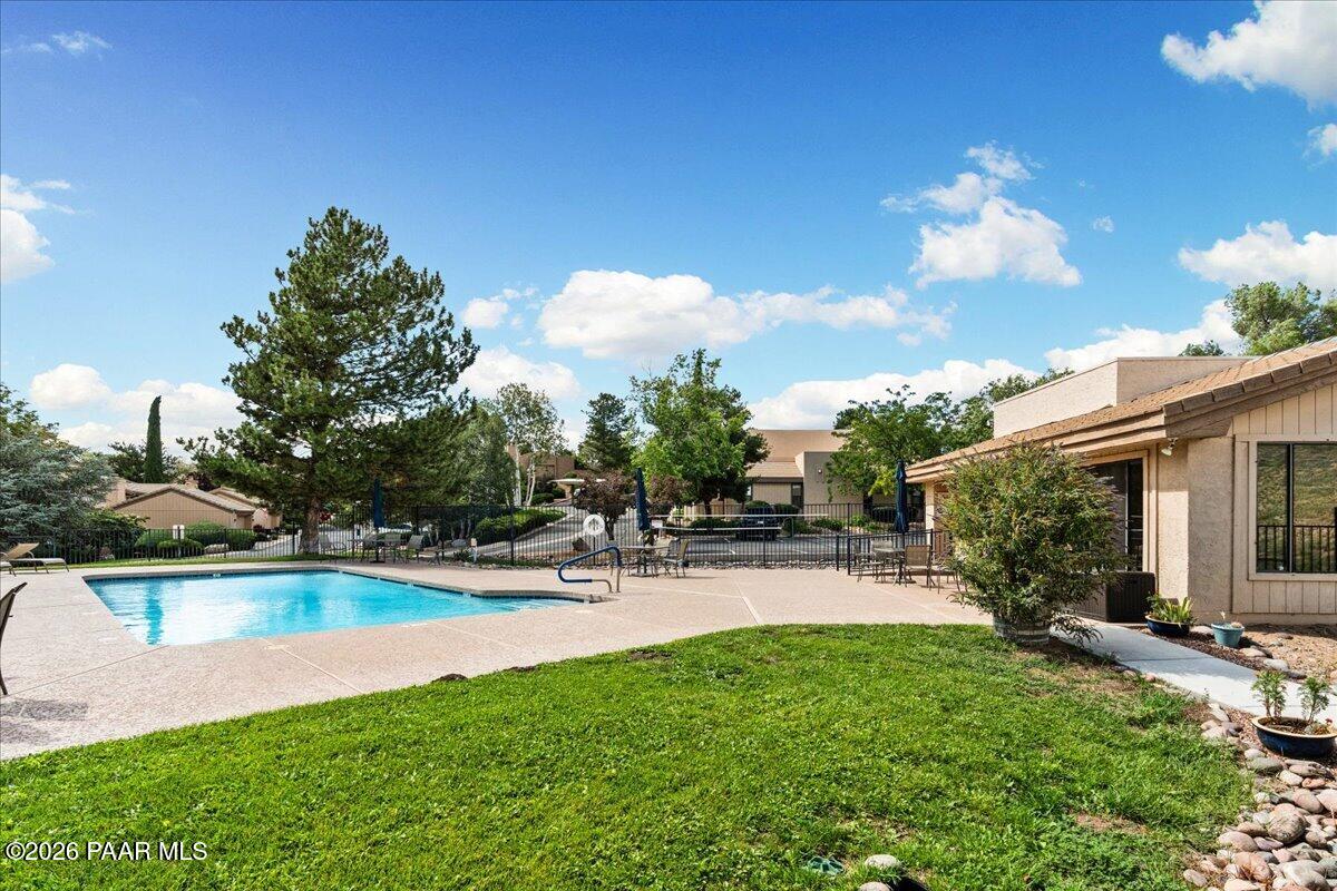 2180 Resort Way South, Unit A7 Prescott, AZ 86301 - Photo 22 of 27 a view of a patio with table and chairs under an umbrella