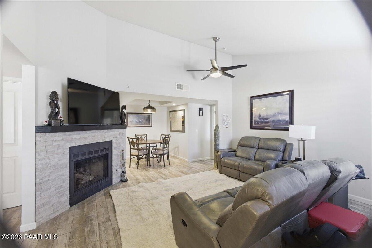2180 Resort Way South, Unit A7 Prescott, AZ 86301 - Photo 3 of 27 a living room with furniture a fireplace and a flat screen tv