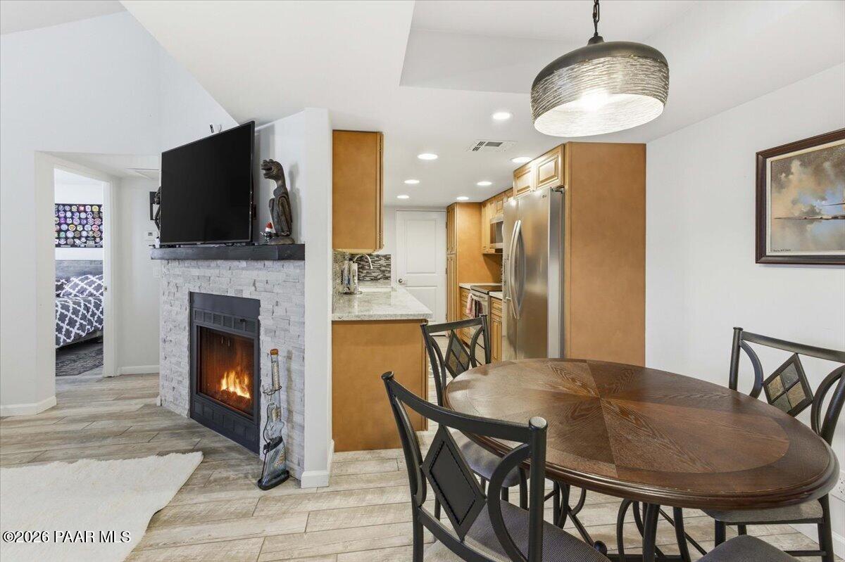 2180 Resort Way South, Unit A7 Prescott, AZ 86301 - Photo 5 of 27 a dining room with furniture and a fireplace
