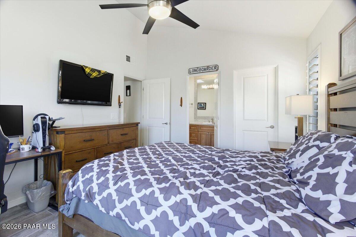 2180 Resort Way South, Unit A7 Prescott, AZ 86301 - Photo 9 of 27 a bedroom with a bed and a flat screen tv