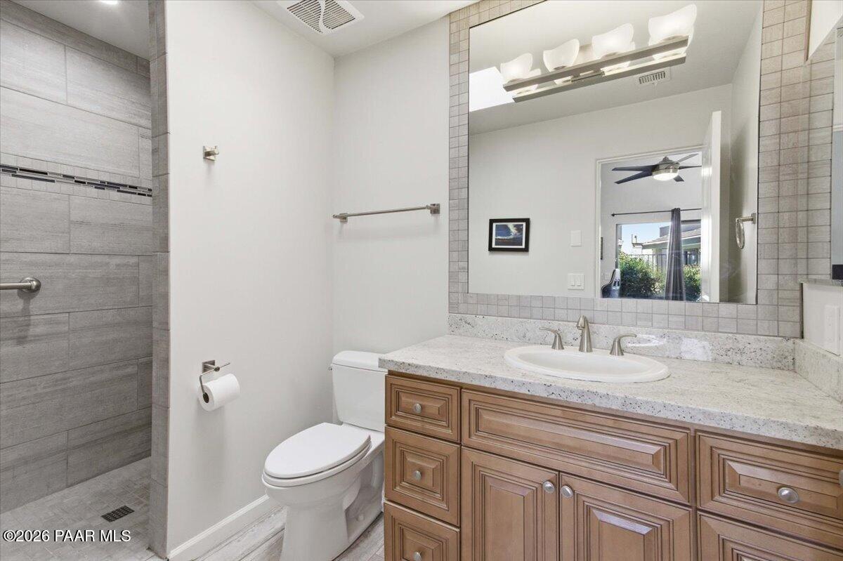 2180 Resort Way South, Unit A7 Prescott, AZ 86301 - Photo 10 of 27 a bathroom with a granite countertop toilet sink and mirror