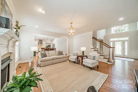 a living room with furniture and a chandelier