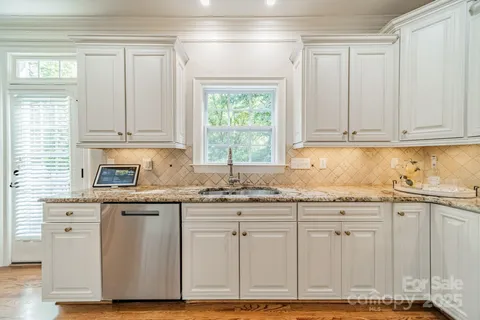 a kitchen with granite countertop cabinets and window