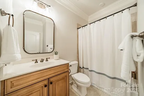 a bathroom with a sink mirror vanity and toilet