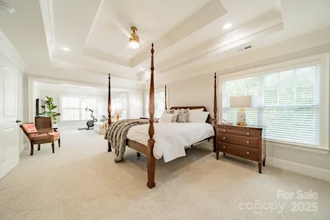 a spacious bedroom with a bed a table and chairs