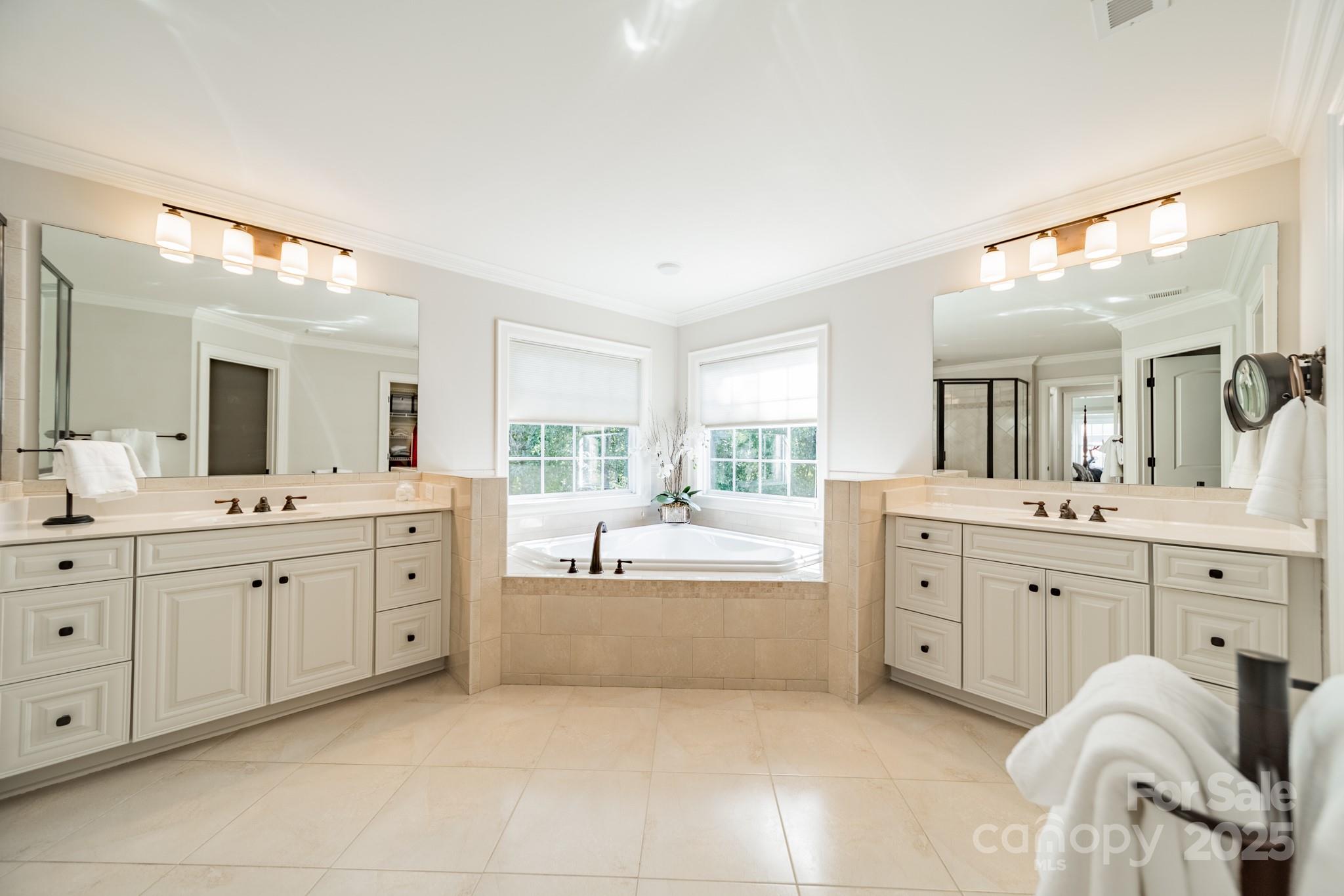 788 Portpatrick Place Fort Mill, SC 29708 - Photo 24 of 48 a large bathroom with a large mirror vanity sink and bathtub