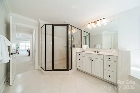 a spacious bathroom with a double vanity sink shower and a mirror