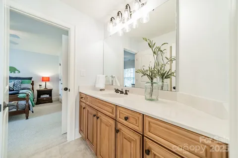 a spacious en suite bathroom with a double vanity sink and a mirror