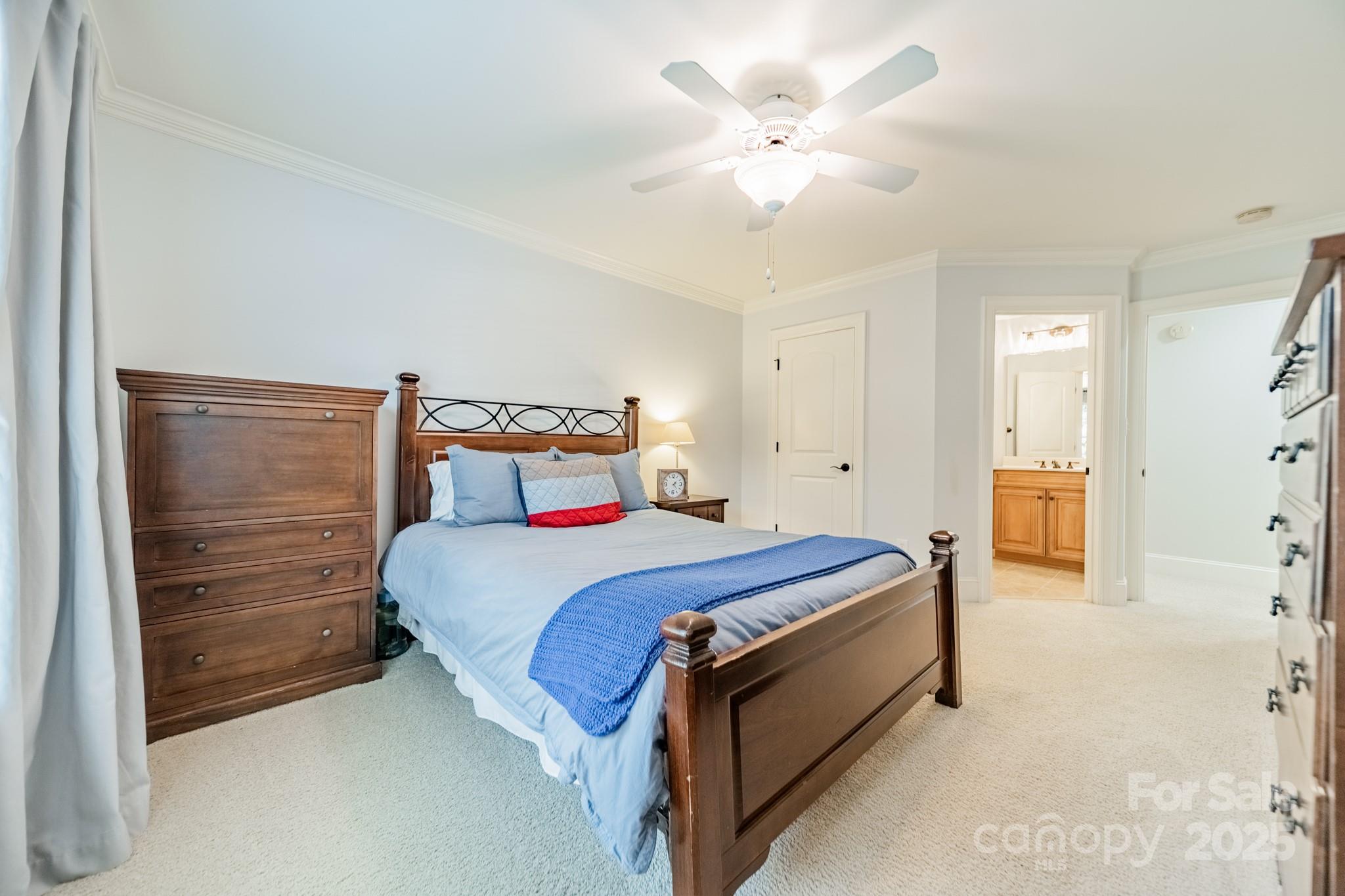 788 Portpatrick Place Fort Mill, SC 29708 - Photo 32 of 48 a spacious bedroom with a bed and a chandelier