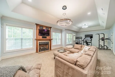 a living room with furniture a fireplace and flat screen tv