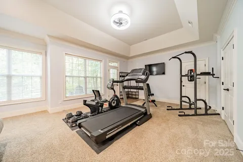 a room with gym equipment and a large window