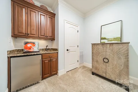 a kitchen with stainless steel appliances granite countertop a refrigerator and a stove top oven