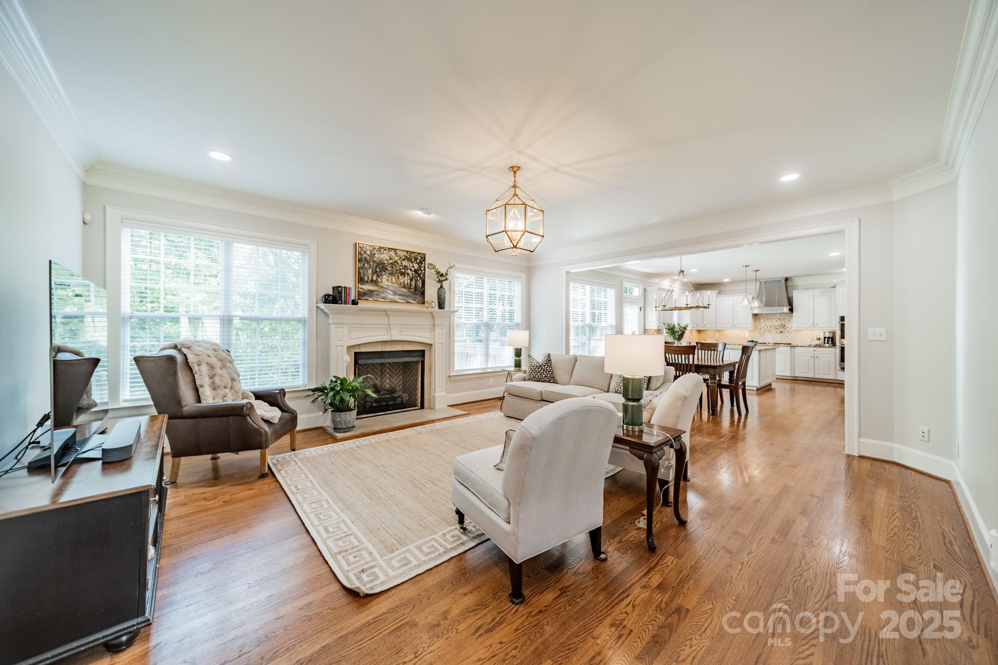 788 Portpatrick Place Fort Mill, SC 29708 - Photo 9 of 48 a living room with fireplace furniture and a wooden floor