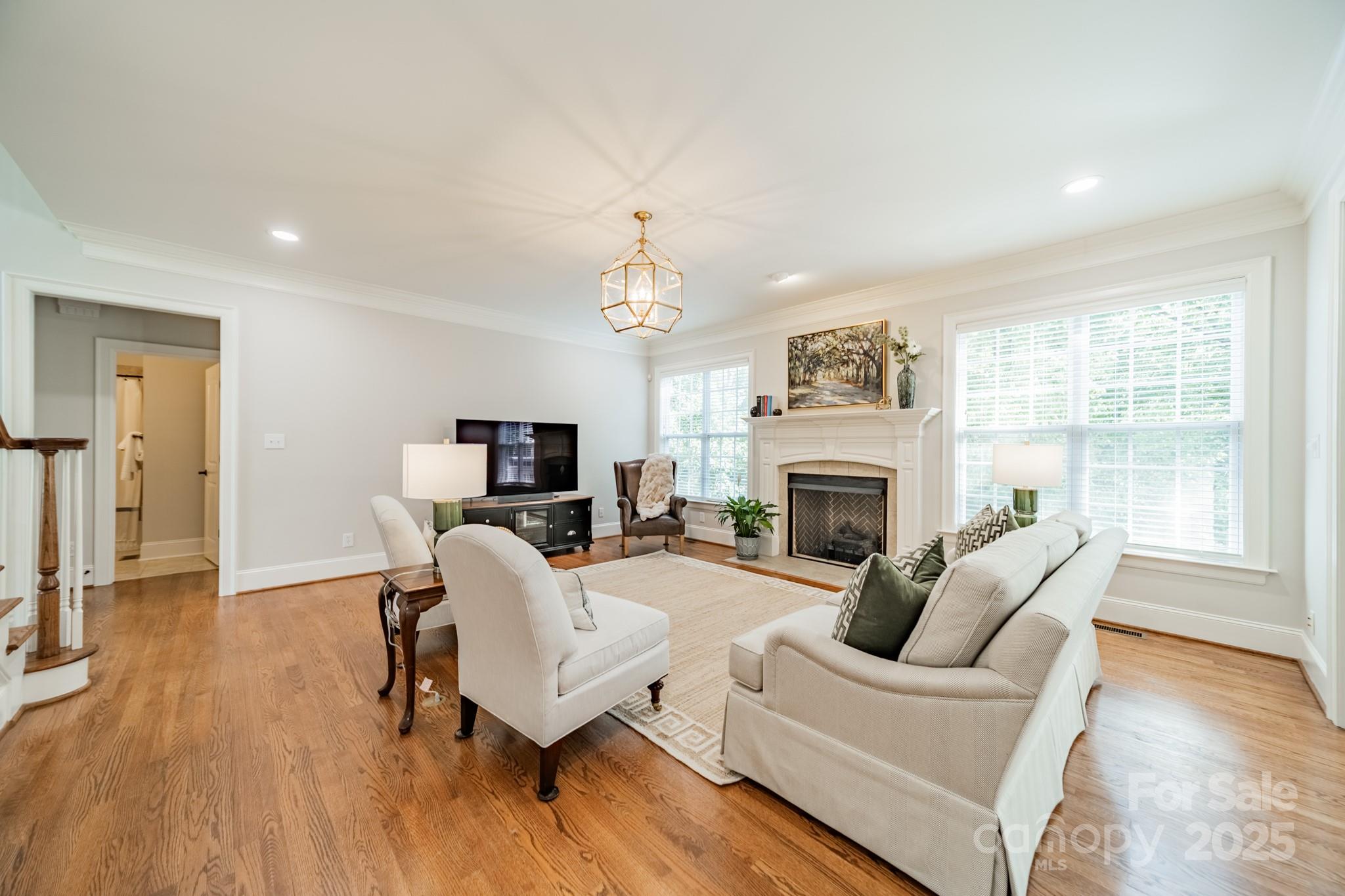 788 Portpatrick Place Fort Mill, SC 29708 - Photo 10 of 48 a living room with furniture a fireplace and a chandelier
